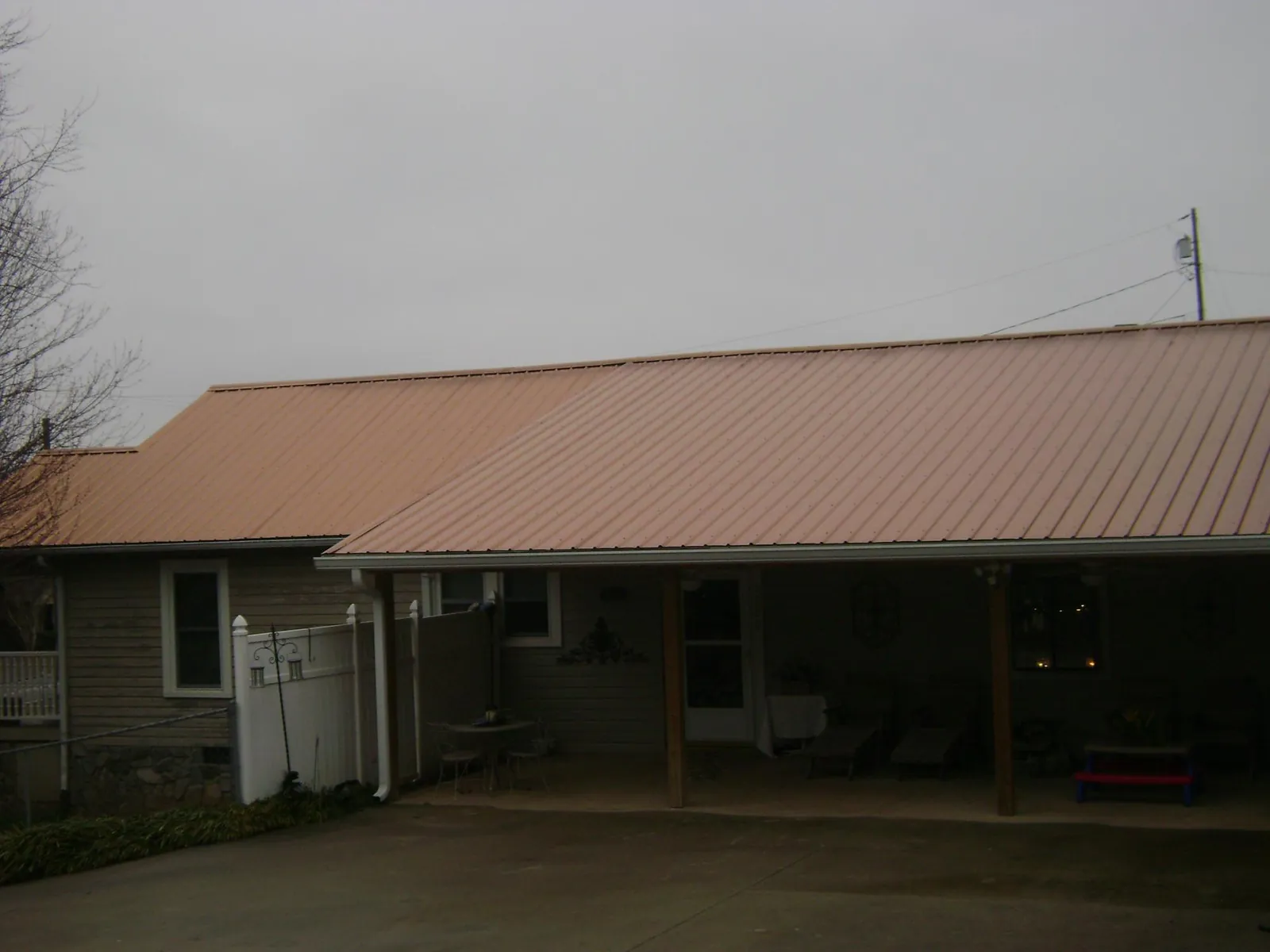 Copper toned metal roof over a wide covered patio in Olmsted Falls